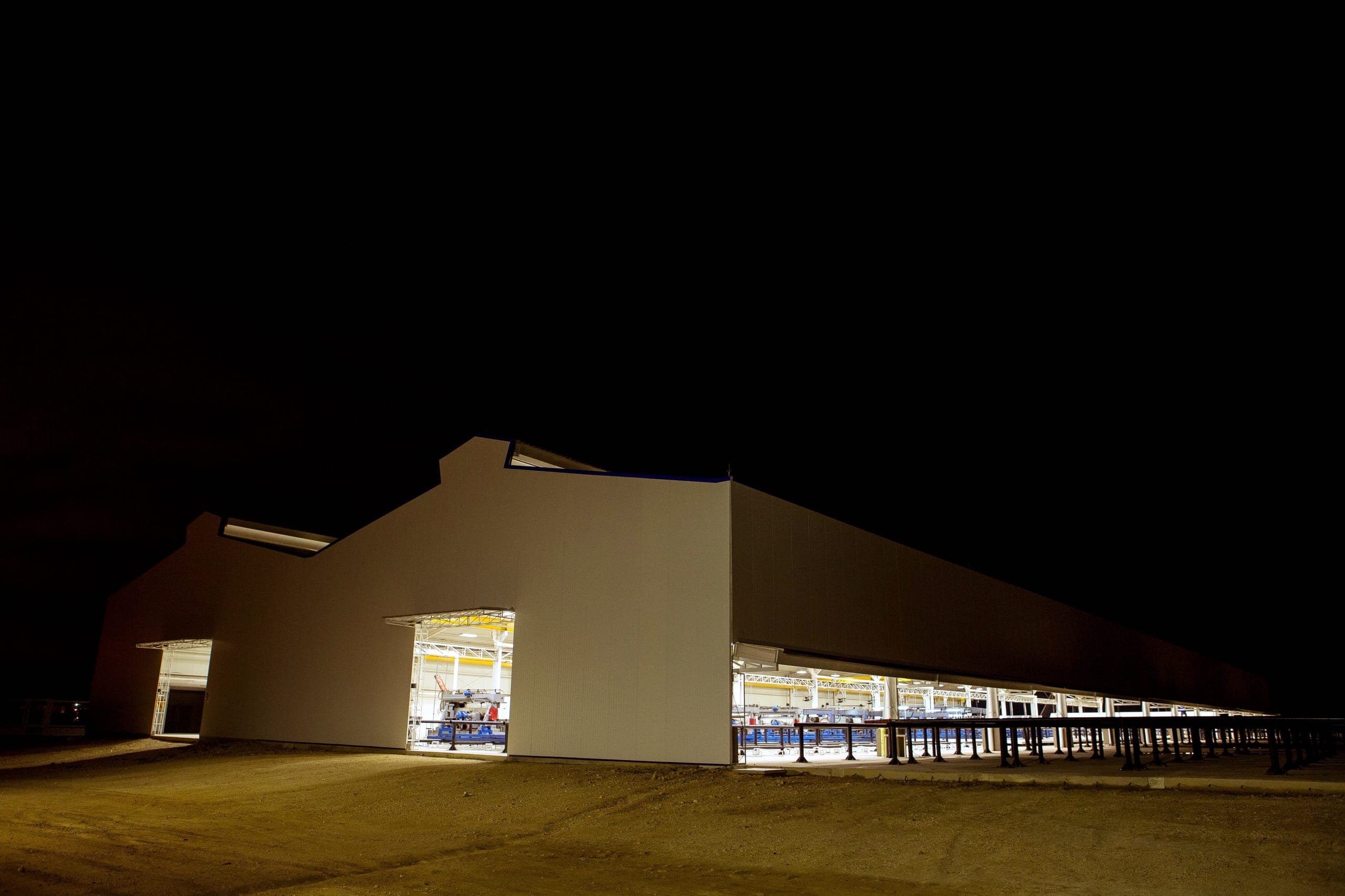 The hall at night, its door and open side lit.