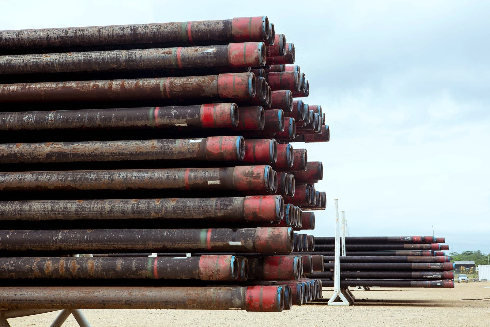 A stack of liners with red-banded ends on a rack, more stacks behind.